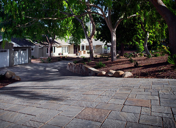 large driveway with gray brick pavers