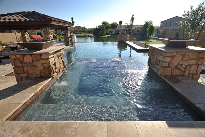 infinity pool in front of river in nice southern residential area