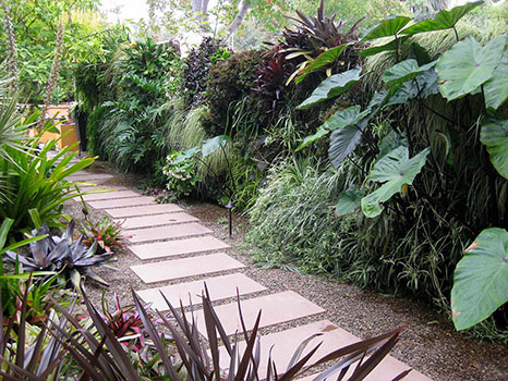 paver slabs leading down winding lush path