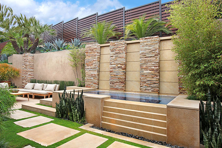 High end retaining wall in lush backyard
